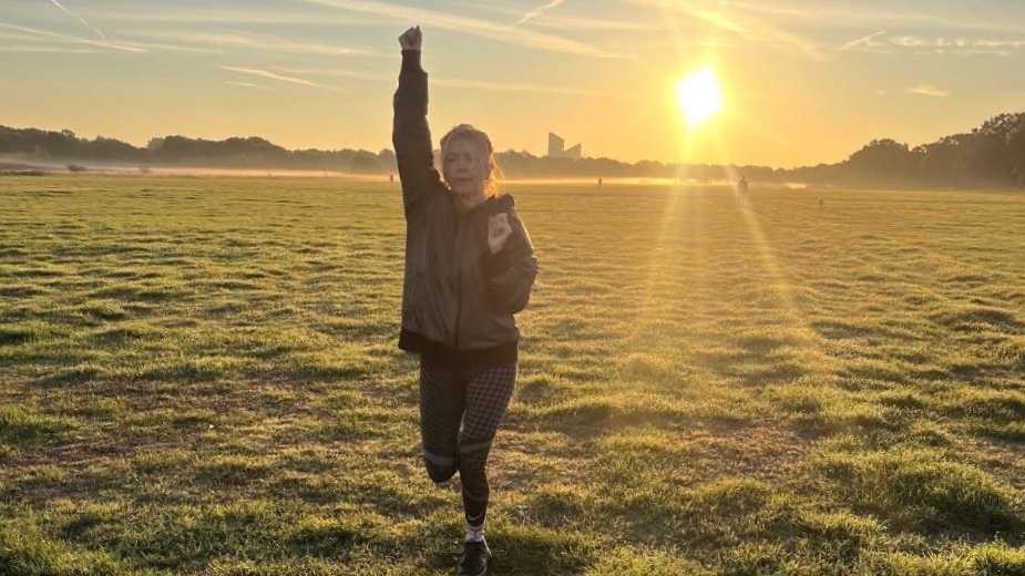 A woman performing outdoor endurance exercises on a sunny field at Wanstead Flats East London